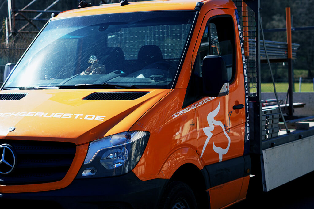 orangener Mercedes Sprinter mit Beschriftung der Firma Gerlach Gerüstbau